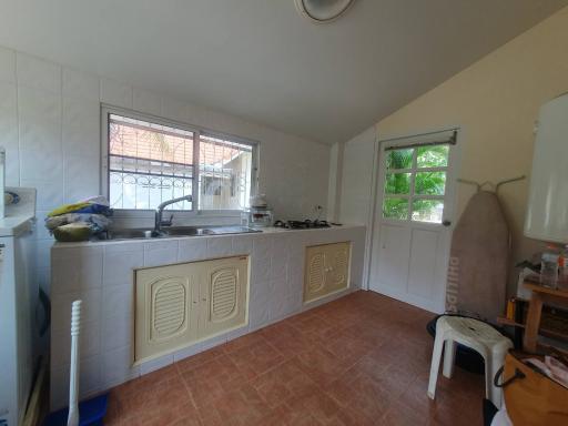 Spacious two-storey house for sale in Chiang Mai, with 2 kitchens, 5 air conditioners, and a large water tank in desirable Koolpunt Ville 9.