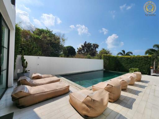 Outdoor pool area with lounge seating