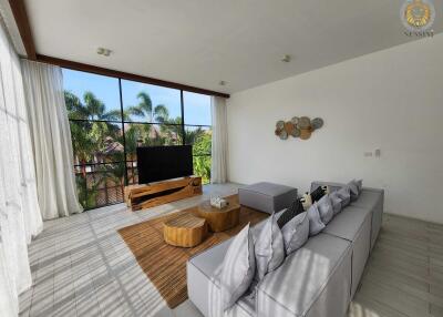 Spacious living room with modern furniture and large windows