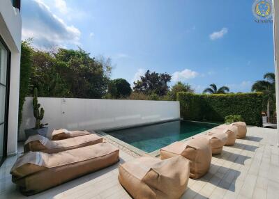 Modern outdoor area with a swimming pool and seating