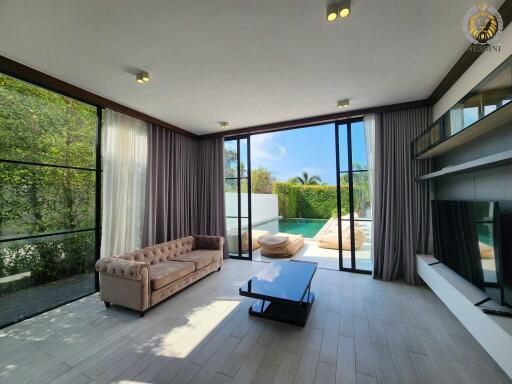 Modern living room with large windows and pool view