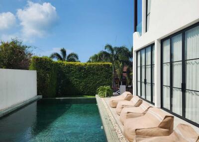 Outdoor pool area with lounge chairs