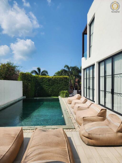 Outdoor pool area with lounge chairs