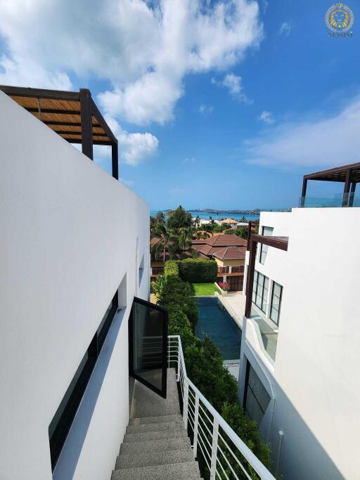 View from a modern building towards a residential neighborhood and sea