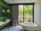 Modern bathroom with large window and standalone tub