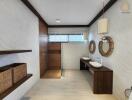 Modern bathroom with double sinks, large shower, and wooden accents