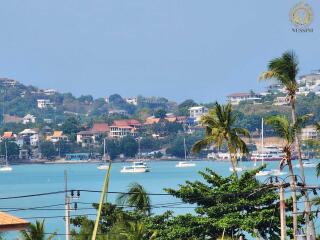 Scenic view of waterfront with boats and residential area