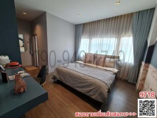 Spacious bedroom with large bed, modern design, and ample natural light