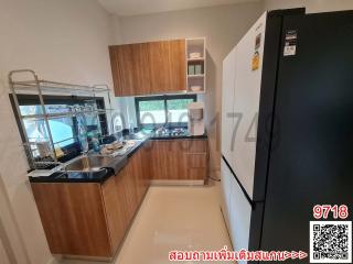 Modern kitchen with wooden cabinets and black countertops