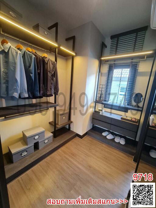 Modern walk-in closet with built-in shelves and hanging space
