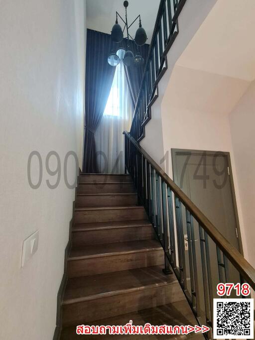 Elegant staircase with wooden steps and wrought iron balusters