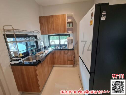 Modern kitchen with wooden cabinets and stainless steel appliances