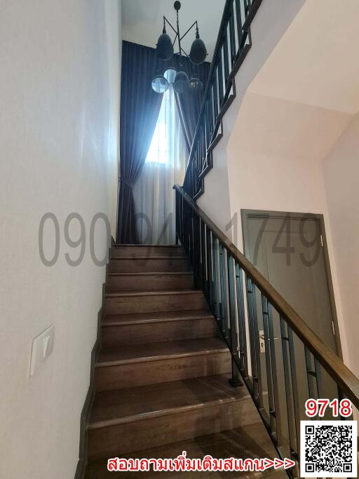 Elegant staircase with wooden steps and wrought iron railing