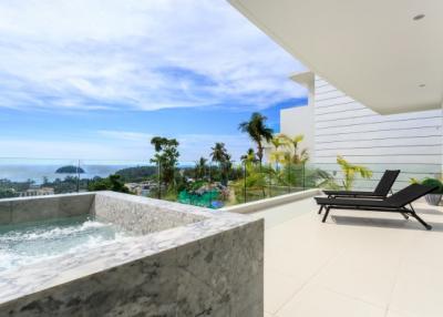 Luxurious balcony with a hot tub overlooking a tropical beach view