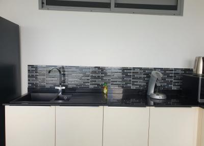 Modern black and white kitchen with mosaic backsplash