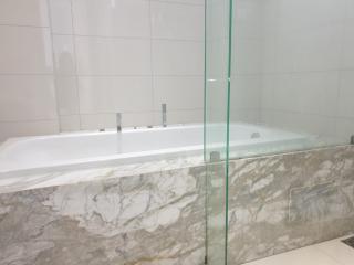 Modern bathroom with marble details and glass shower partition
