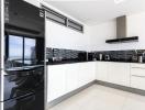 Modern kitchen with black and white color scheme and ocean view