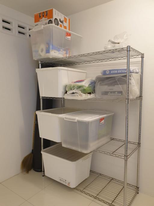 Metal shelving unit with storage boxes in a small room