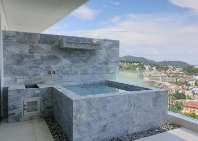 Luxurious balcony with marble finish and private jacuzzi overlooking cityscape