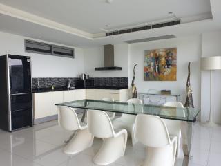 Modern kitchen with dining area, open plan layout with art on the wall