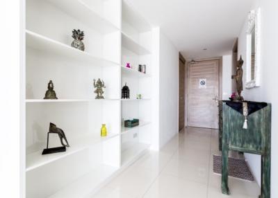 Elegantly decorated hallway with built-in shelving units and modern art pieces