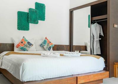 Modern bedroom with white walls and decorative pillows