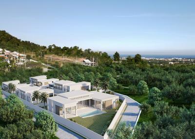 Modern residential buildings with balconies in a green landscaped area overlooking the sea
