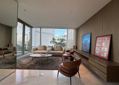 Modern living room interior with large windows, contemporary furniture, and wall art