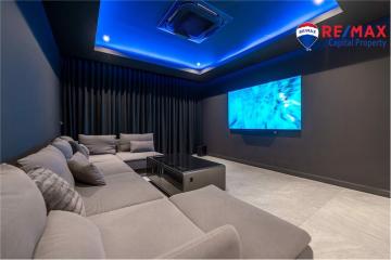 Modern home theater room with large screen and comfortable seating