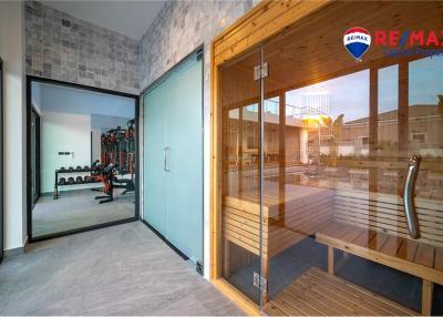 Modern home gym and sauna with large windows and natural light