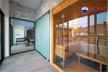 Modern home gym and sauna with large windows and natural light