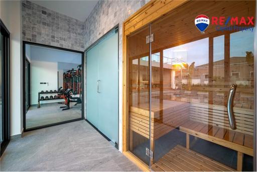 Modern home gym and sauna with large windows and natural light