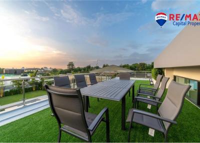 Spacious terrace with dining set and sunset view