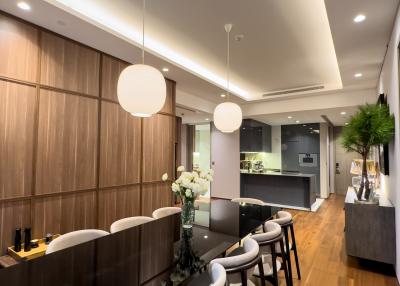 Modern kitchen with integrated dining area and stylish pendant lighting
