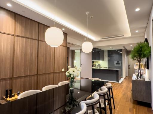 Modern kitchen with integrated dining area and stylish pendant lighting