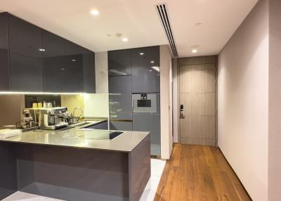 Modern kitchen with stainless steel appliances and wooden flooring