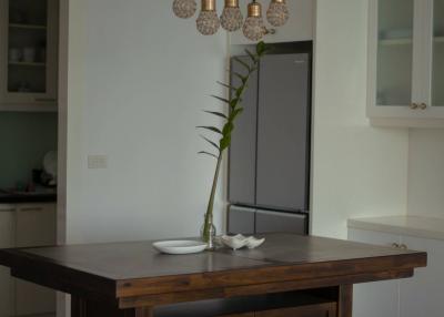 Modern dining area with designer lights and wooden table