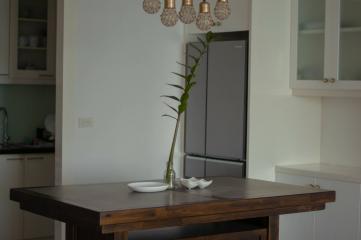 Modern dining area with designer lights and wooden table