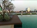 Outdoor swimming pool with lounge chairs and city view