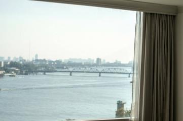 View from a high-rise building window overlooking a river and bridge