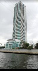 Modern high-rise residential building from a waterfront perspective