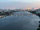 Panoramic river view with bridges and cityscape during sunset