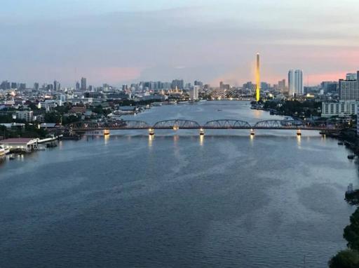 Panoramic river view with bridges and cityscape during sunset