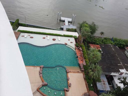 Aerial view of an outdoor swimming pool next to a river