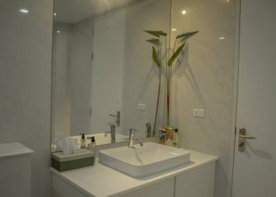 Modern bathroom interior with white basin and accessories