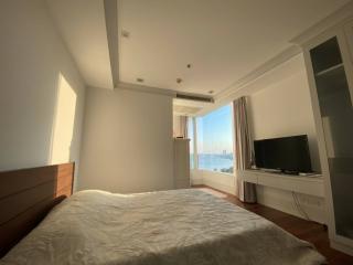 Spacious bedroom with natural lighting and a view