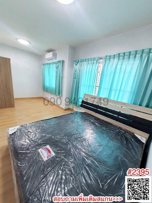 Spacious Bedroom with Large Bed and Turquoise Curtains
