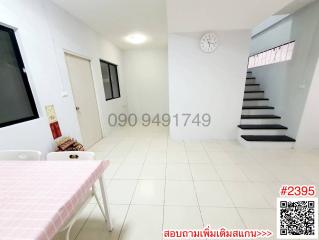 Spacious and well-lit main living area with staircase and tiled flooring