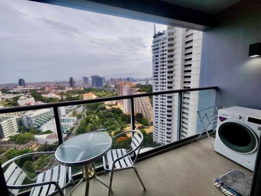 High-rise apartment balcony overlooking the city with outdoor furniture