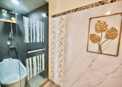 Modern bathroom with enclosed shower and decorative wall art